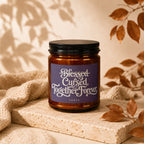 Glass candle with purple label reading "Blessed Cursed Together Forever Vowed".