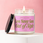 Candle with pink label that reads "Love Never Goes Out of Style"