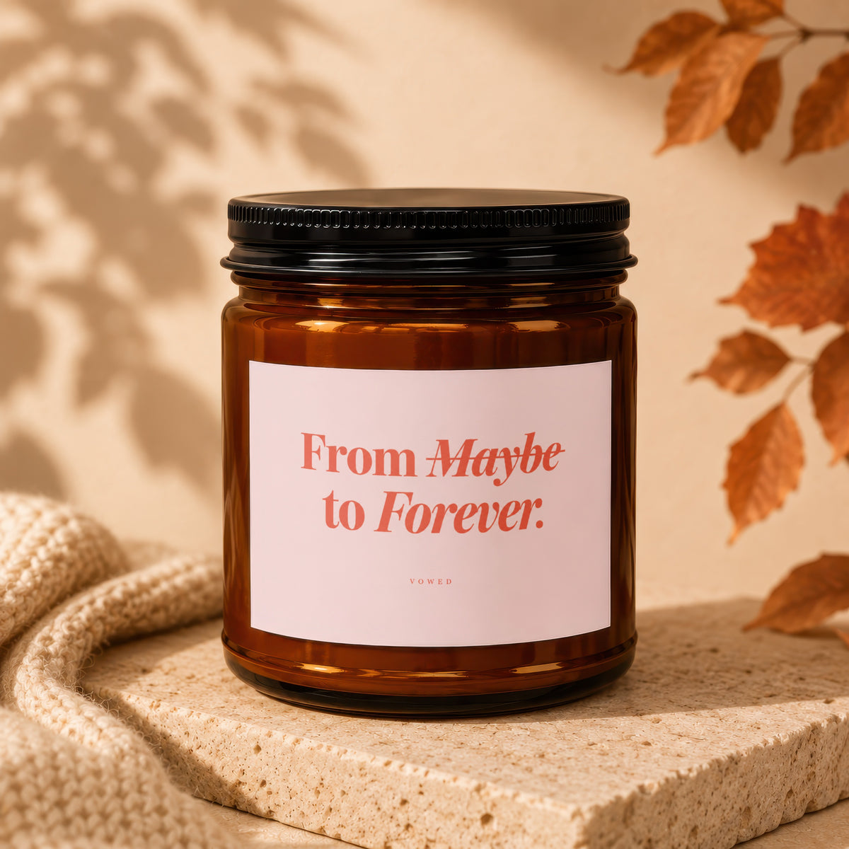 Amber jar candle with label reading "From Maybe to Forever. VOWED."