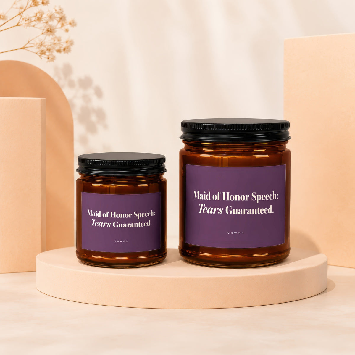 Two amber glass candles with purple labels reading "Maid of Honor Speech: Tears Guaranteed."