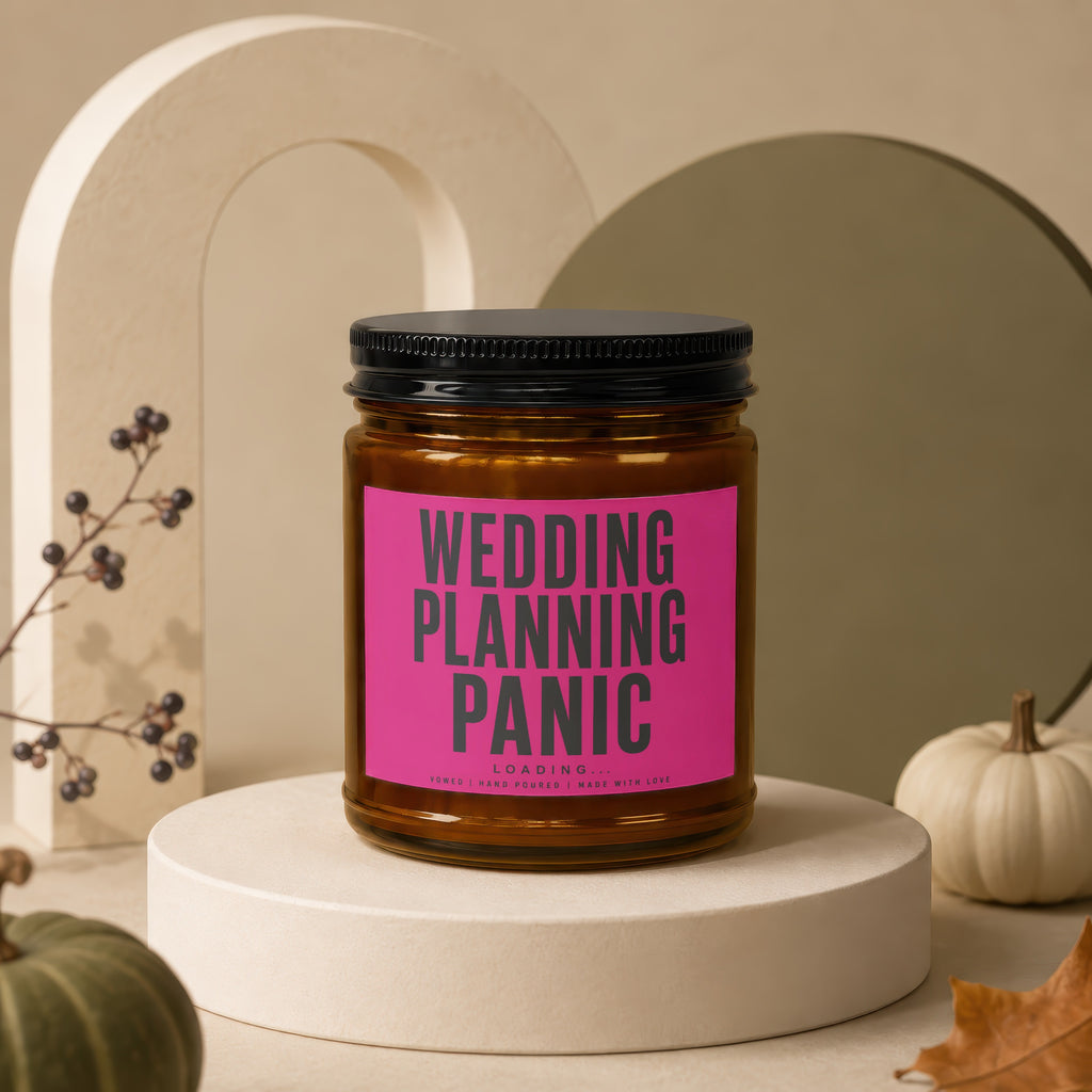 Amber jar candle with pink label reading "WEDDING PLANNING PANIC LOADING..."