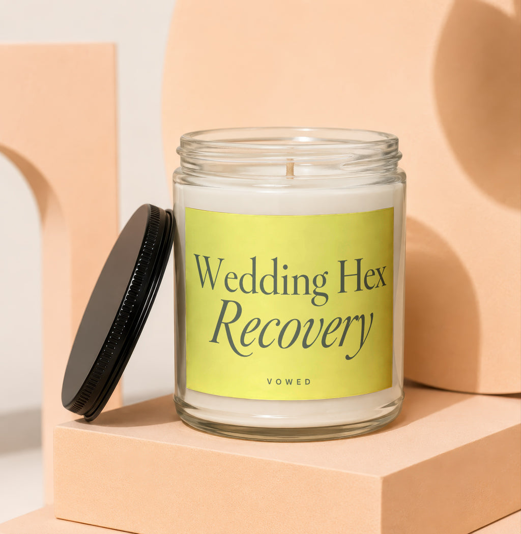 Glass candle with yellow label reading "Wedding Hex Recovery" by VOWED