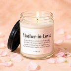 Lit candle in a glass jar with a pink label reading "Mother-in-Love"