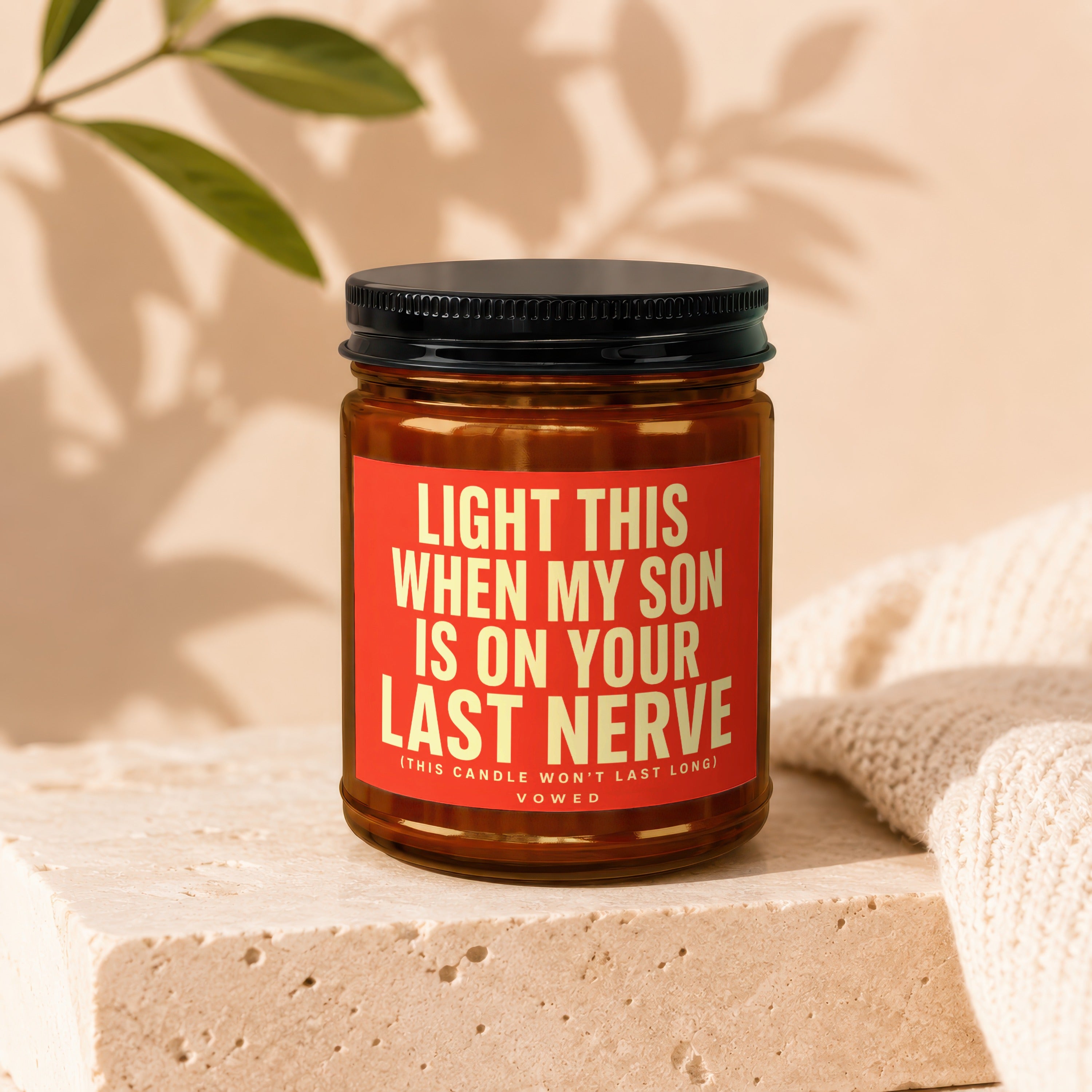 Amber candle with red label reading "Light this when my son is on your last nerve."