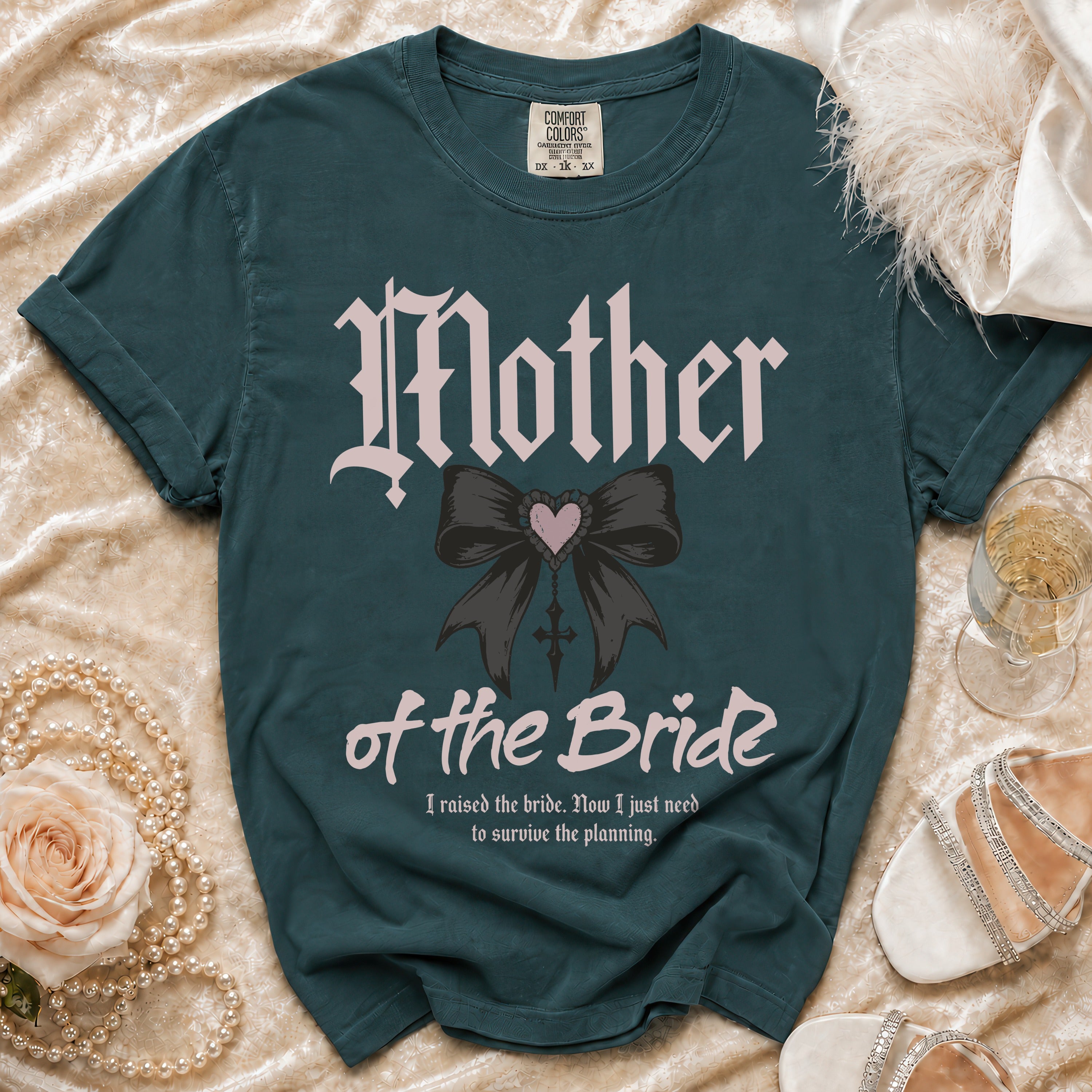 Teal t-shirt with "Mother of the Bride" text, a bow, and a wedding planning quote.
