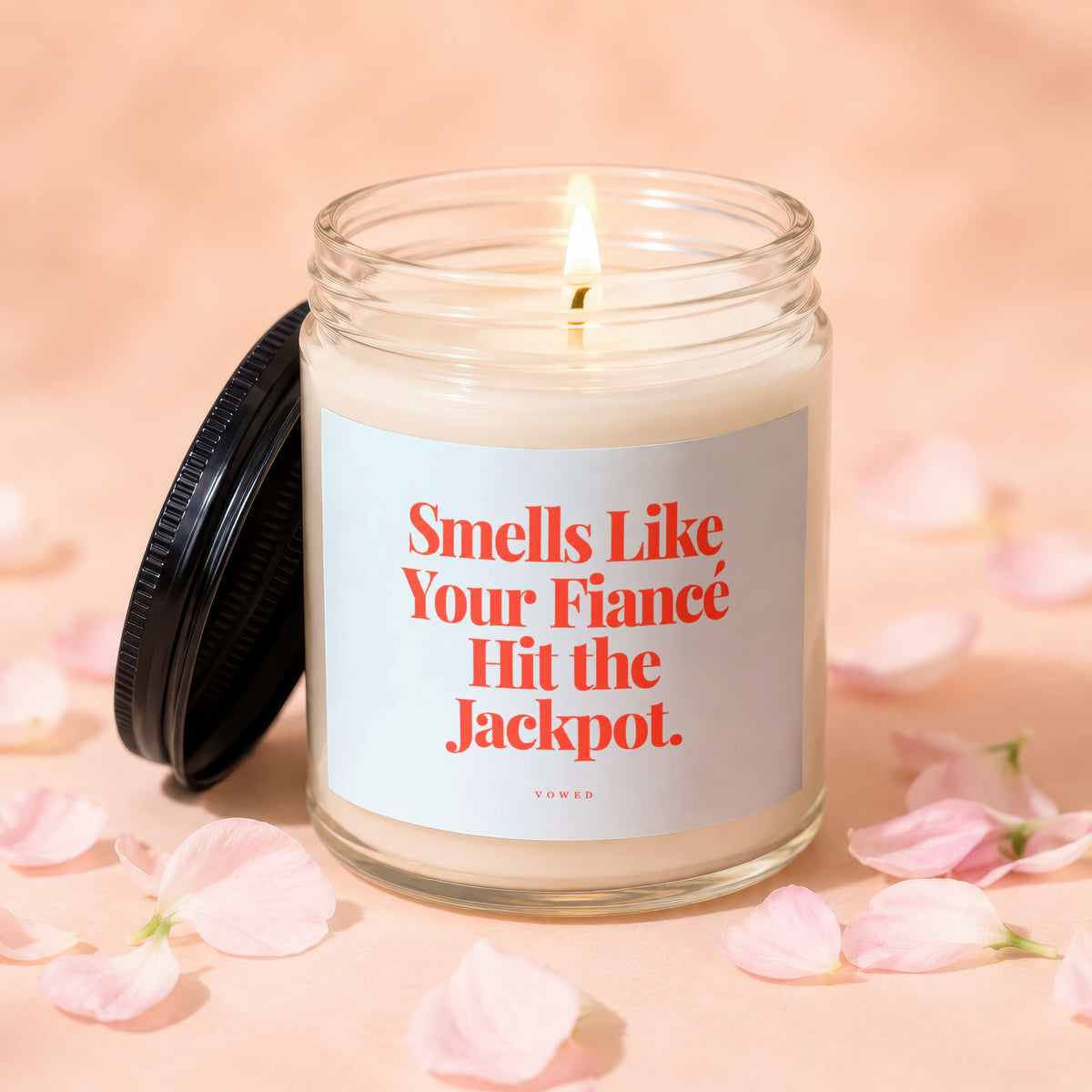 Lit candle with text "Smells Like Your Fiancé Hit the Jackpot."