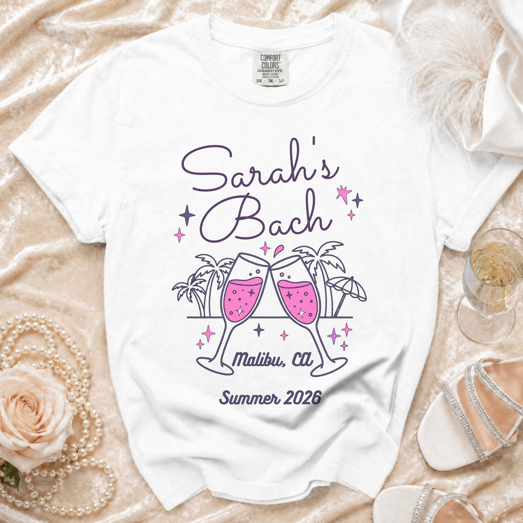 White t-shirt with "Sarah's Bach Malibu, Ca Summer 2026" and champagne glasses.
