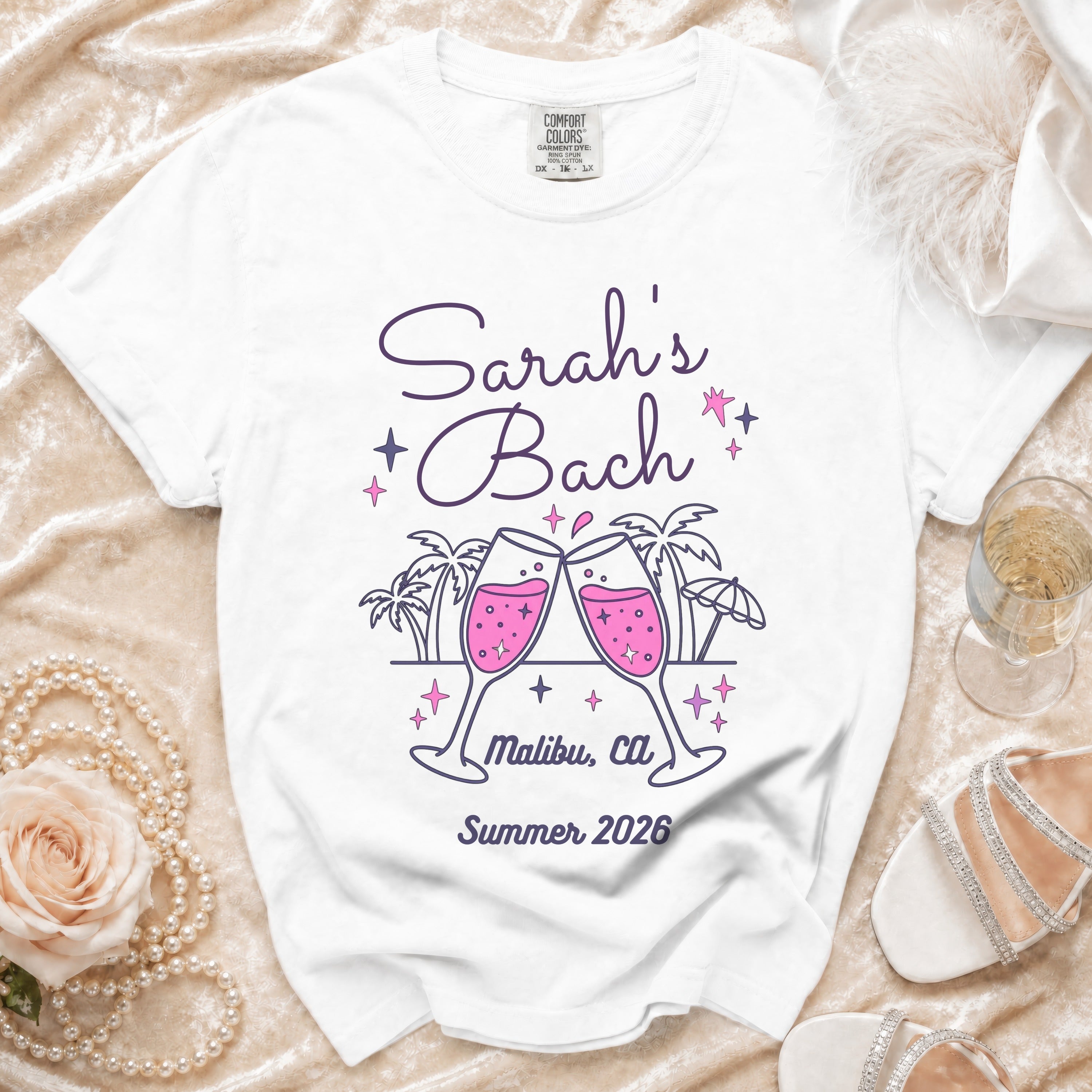 White t-shirt with "Sarah's Bach Malibu, Ca Summer 2026" and champagne glasses.