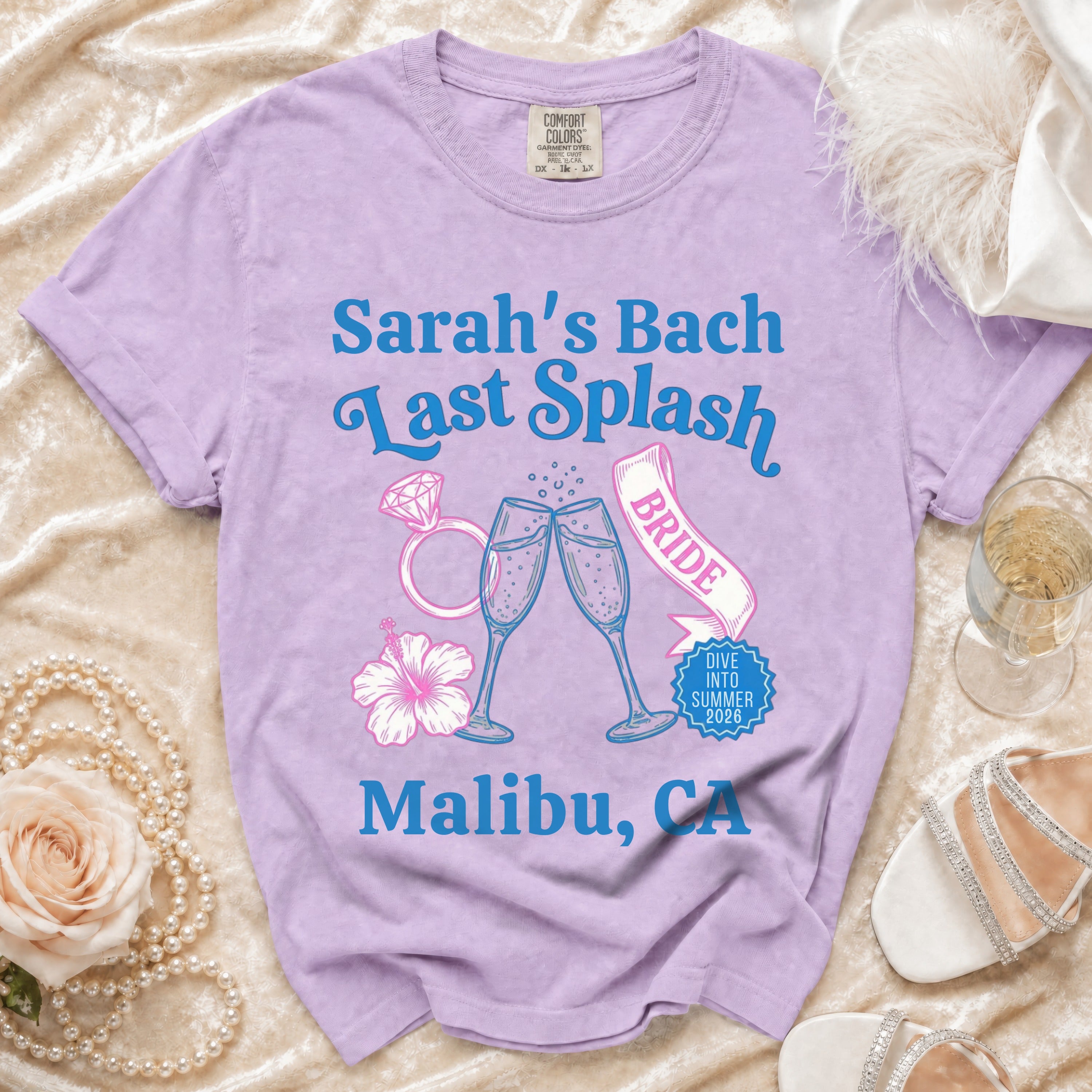 Lilac t-shirt with "Sarah's Bach Last Splash" and champagne glasses design.