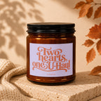 Amber candle with "Two hearts, one U-Haul" text and "VOWED" below.