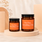 Two amber jars with black lids, orange labels read "I'm Fine. Everything's Fine."
