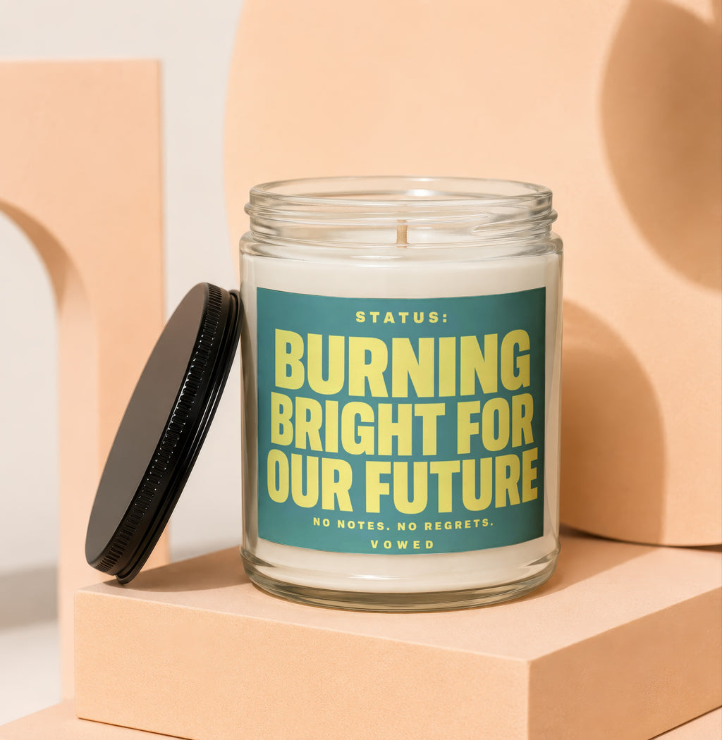 Candle with text "STATUS: BURNING BRIGHT FOR OUR FUTURE NO NOTES. NO REGRETS. VOWED."