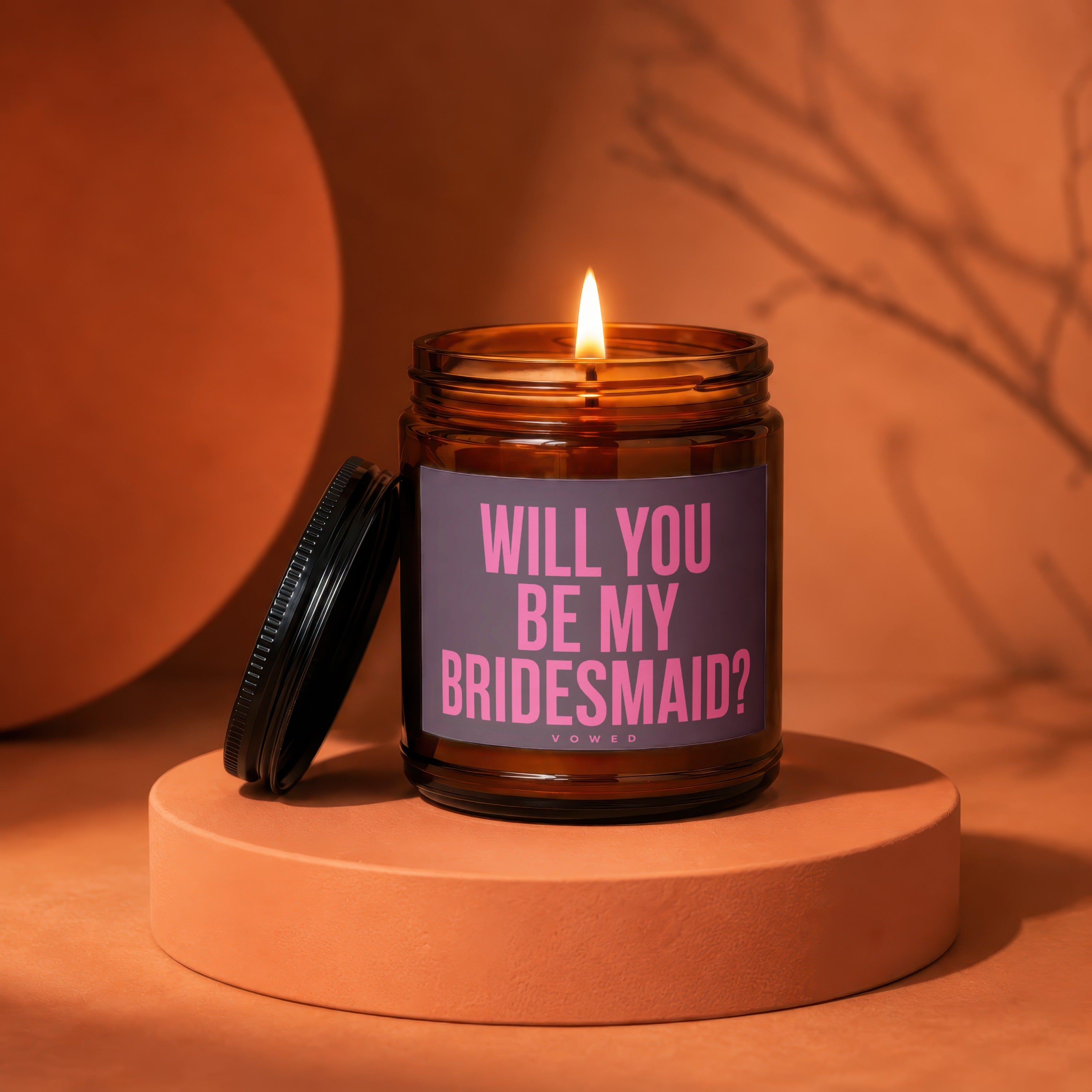 Amber jar candle with text "Will you be my bridesmaid?" on a dusty rose label.