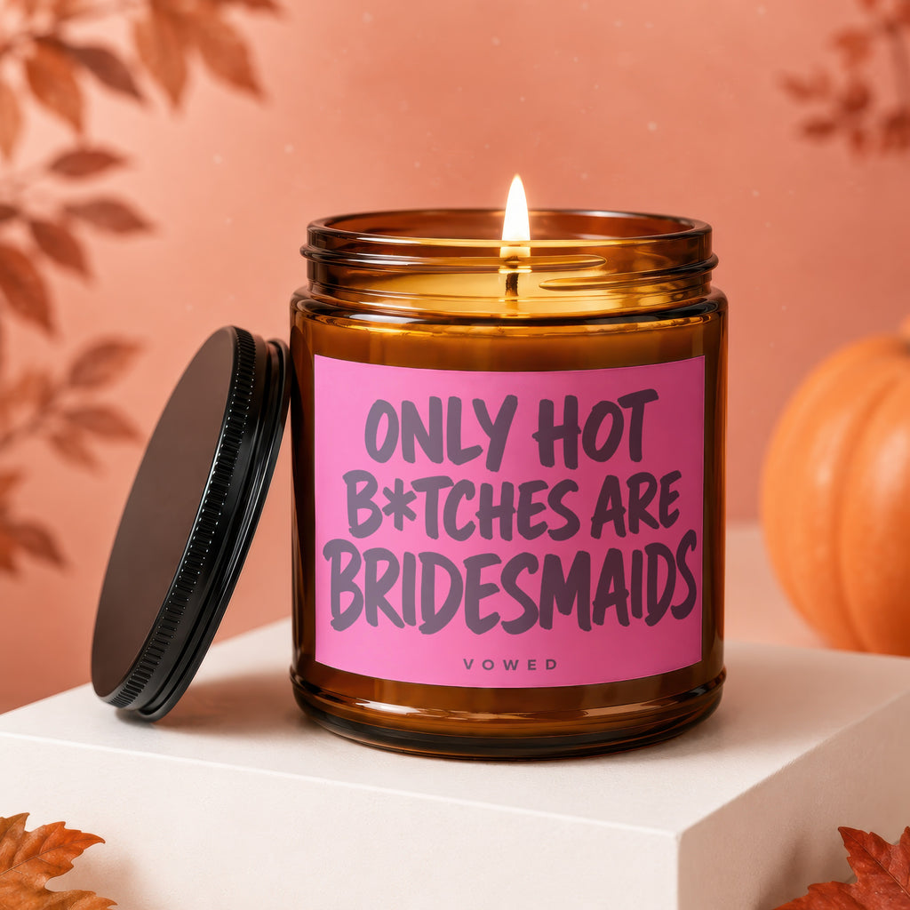 Amber candle with pink label saying "Only Hot Bitches Are Bridesmaids" and "Vowed".