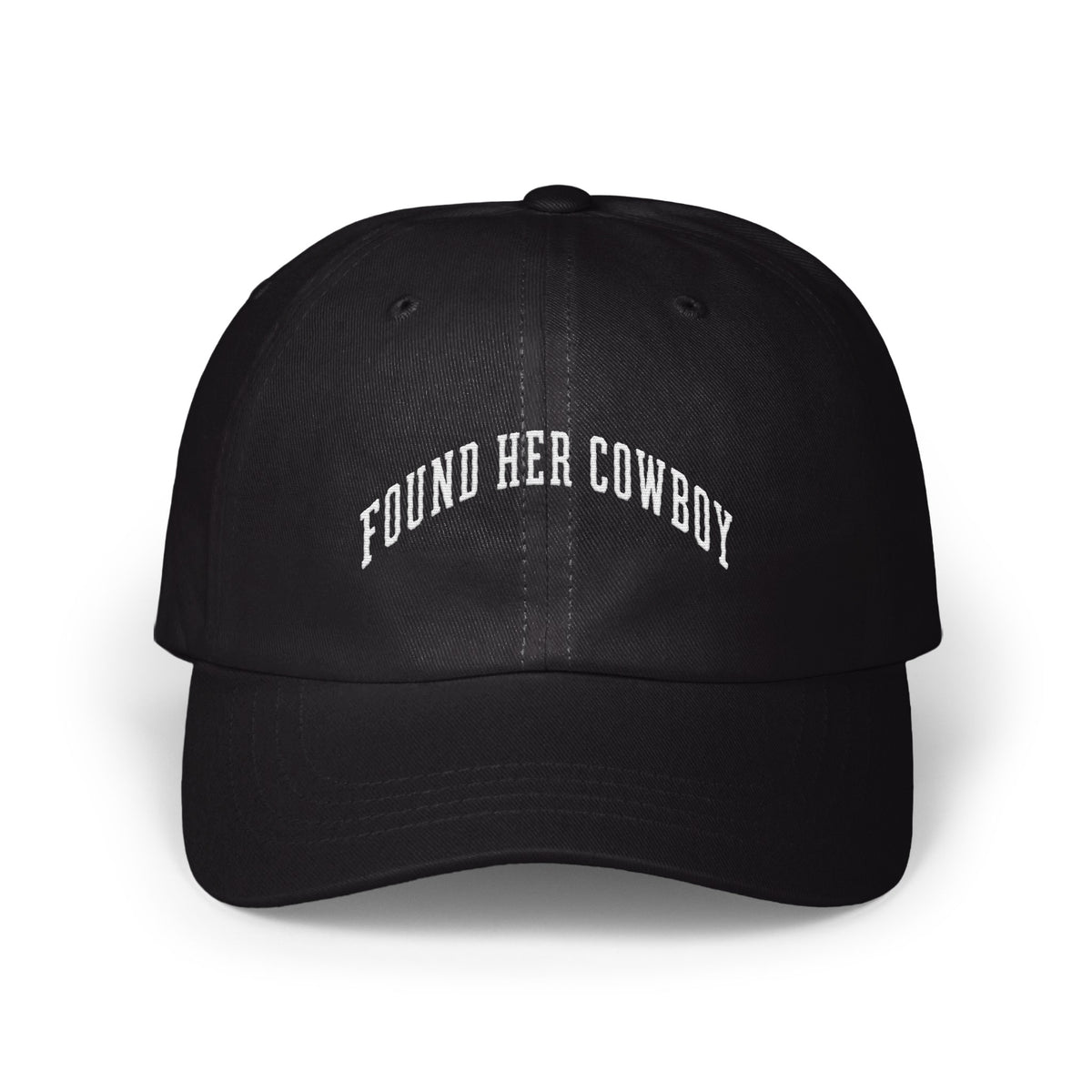 A black baseball cap with white embroidered text reading "FOUND HER COWBOY" arched across the front.