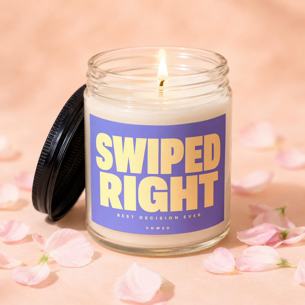Glass candle with purple label reading "SWIPED RIGHT BEST DECISION EVER VOWED."