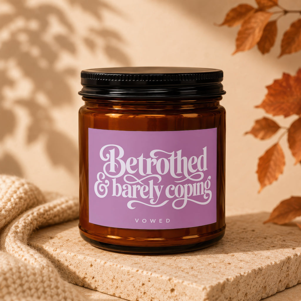 Amber candle labeled "Betrothed & barely coping" with "vowed" below.