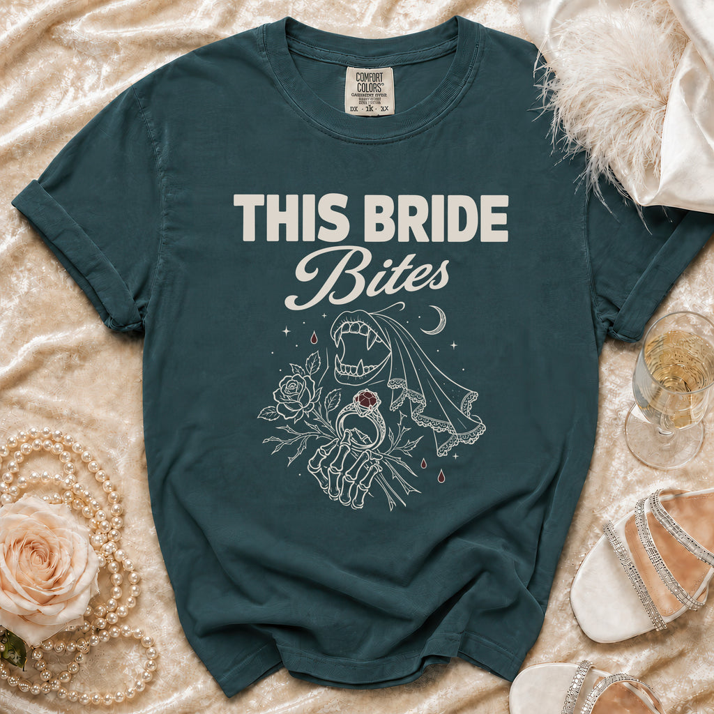 Teal t-shirt with white text "THIS BRIDE Bites" and vampire-themed graphic.