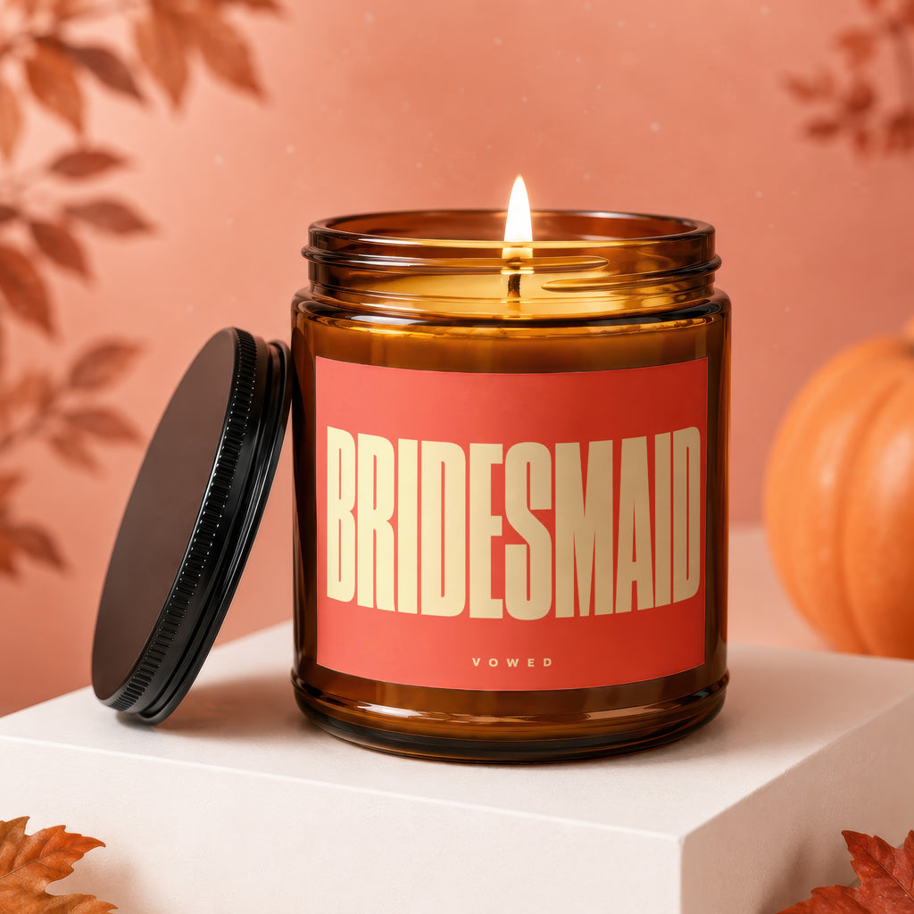 Amber jar candle with "BRIDESMAID" in block letters on a red label.