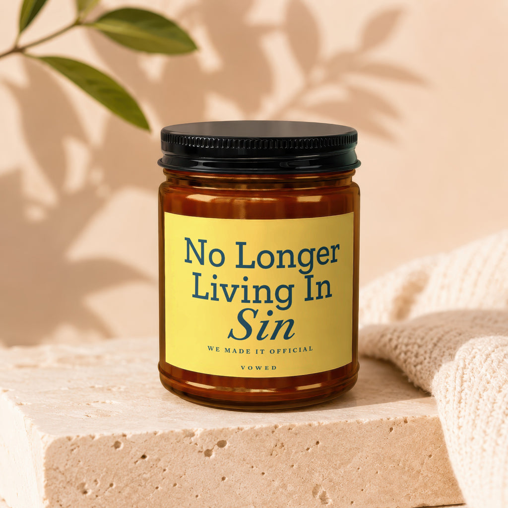 Amber jar candle with yellow label reading "No Longer Living In Sin".