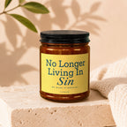 Amber jar candle with yellow label reading "No Longer Living In Sin".