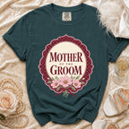 Teal t-shirt with "Mother of the Groom" text and pink floral design.