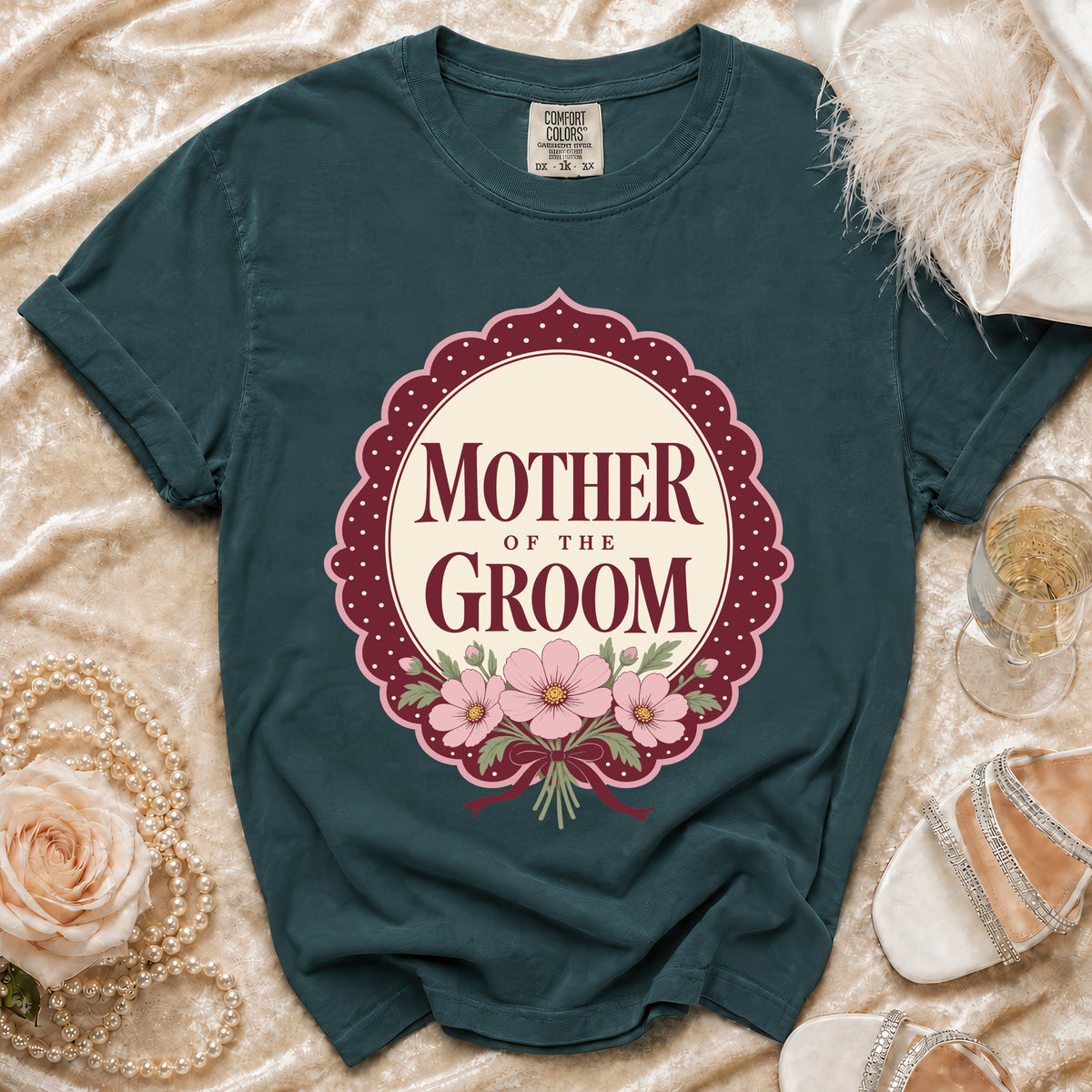 Teal t-shirt with "Mother of the Groom" text and pink floral design.