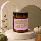 Candle with pink label reading "Welcome to my breakdown big day"