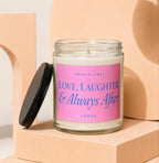 Glass candle with pink label that reads "Smells Like Love, Laughter & Always After"