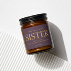Amber glass candle with "Sister, Will You Be My Bridesmaid?" text on label.