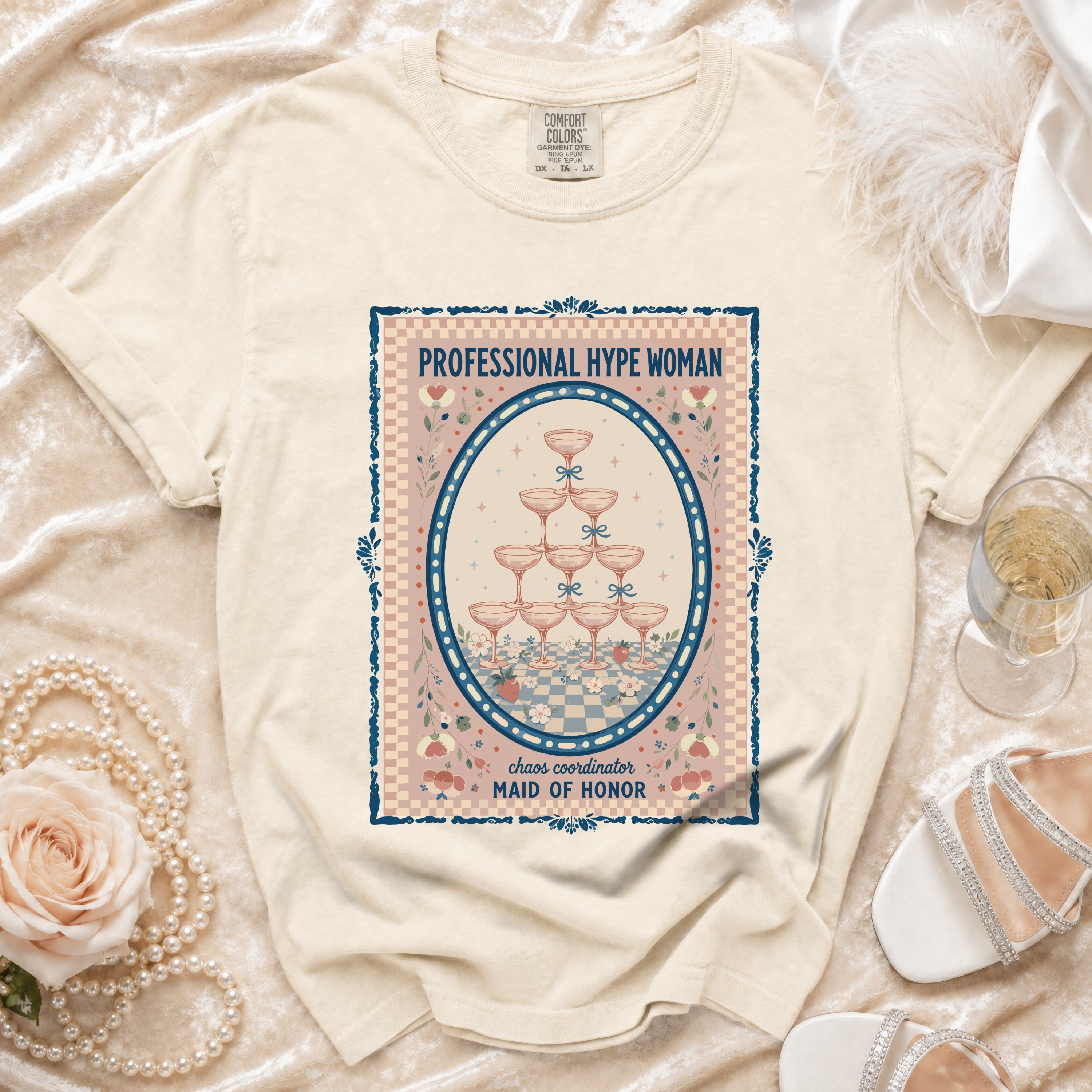 Cream t-shirt with oval graphic: "PROFESSIONAL HYPE WOMAN, chaos coordinator MAID OF HONOR".