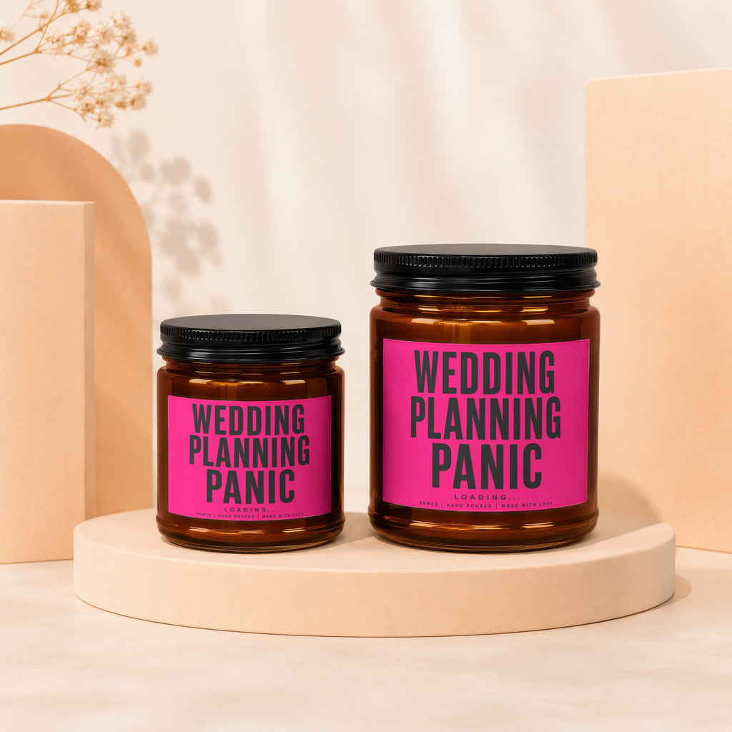 Two candles with "WEDDING PLANNING PANIC" text on pink labels.