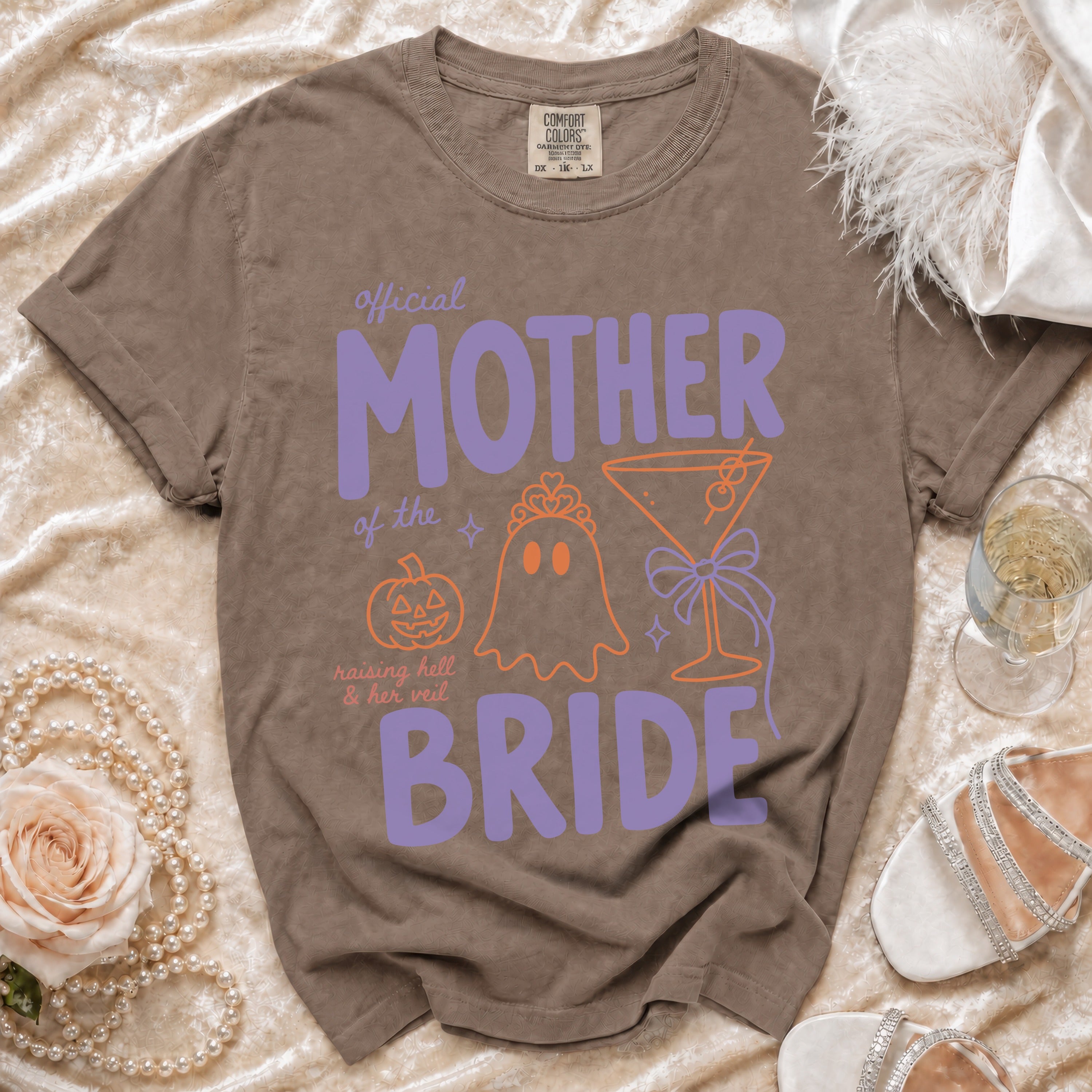Brown Comfort Colors t-shirt with "Official Mother of the Bride" in purple and orange graphics.