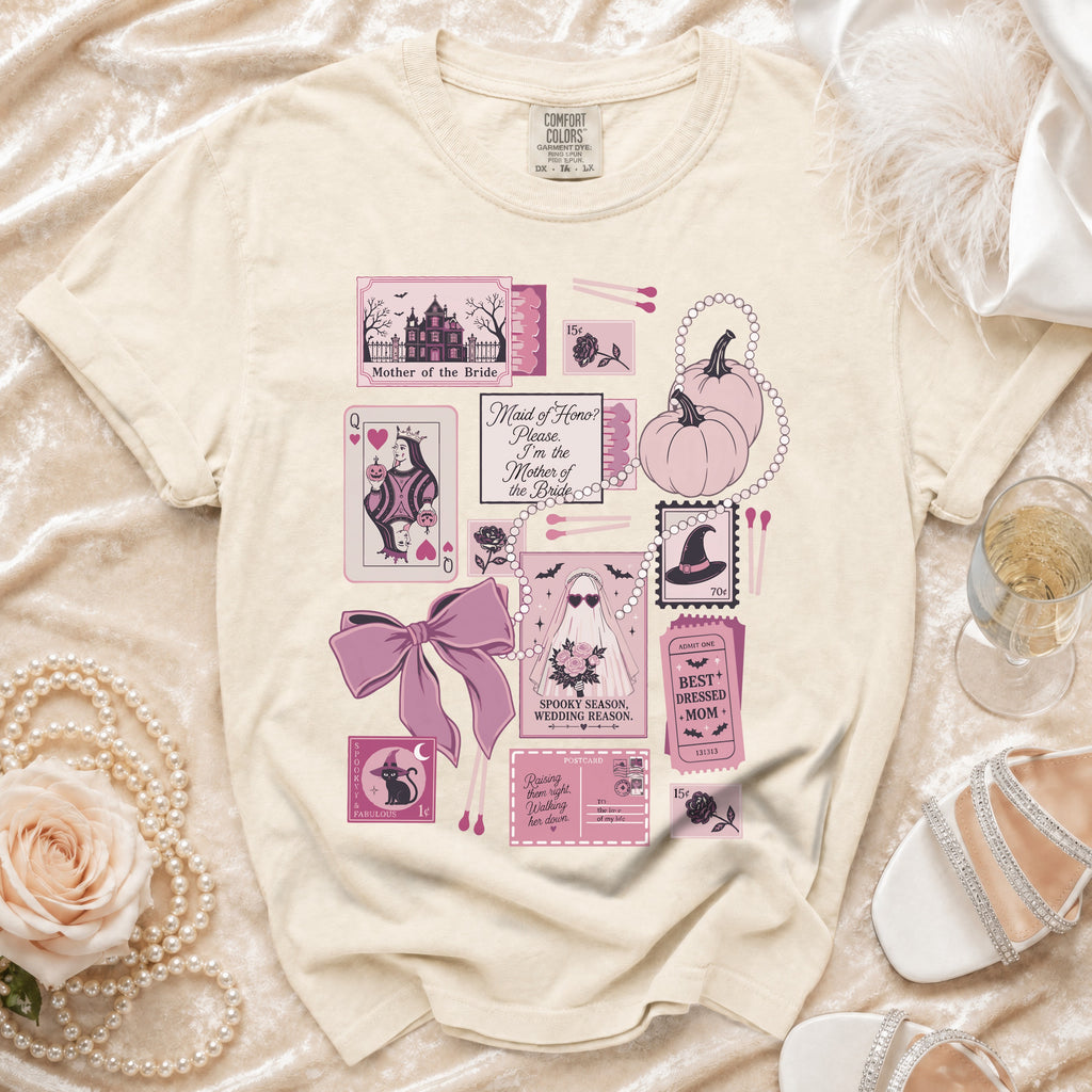 Cream t-shirt with pink Halloween-themed graphic including haunted house and text.