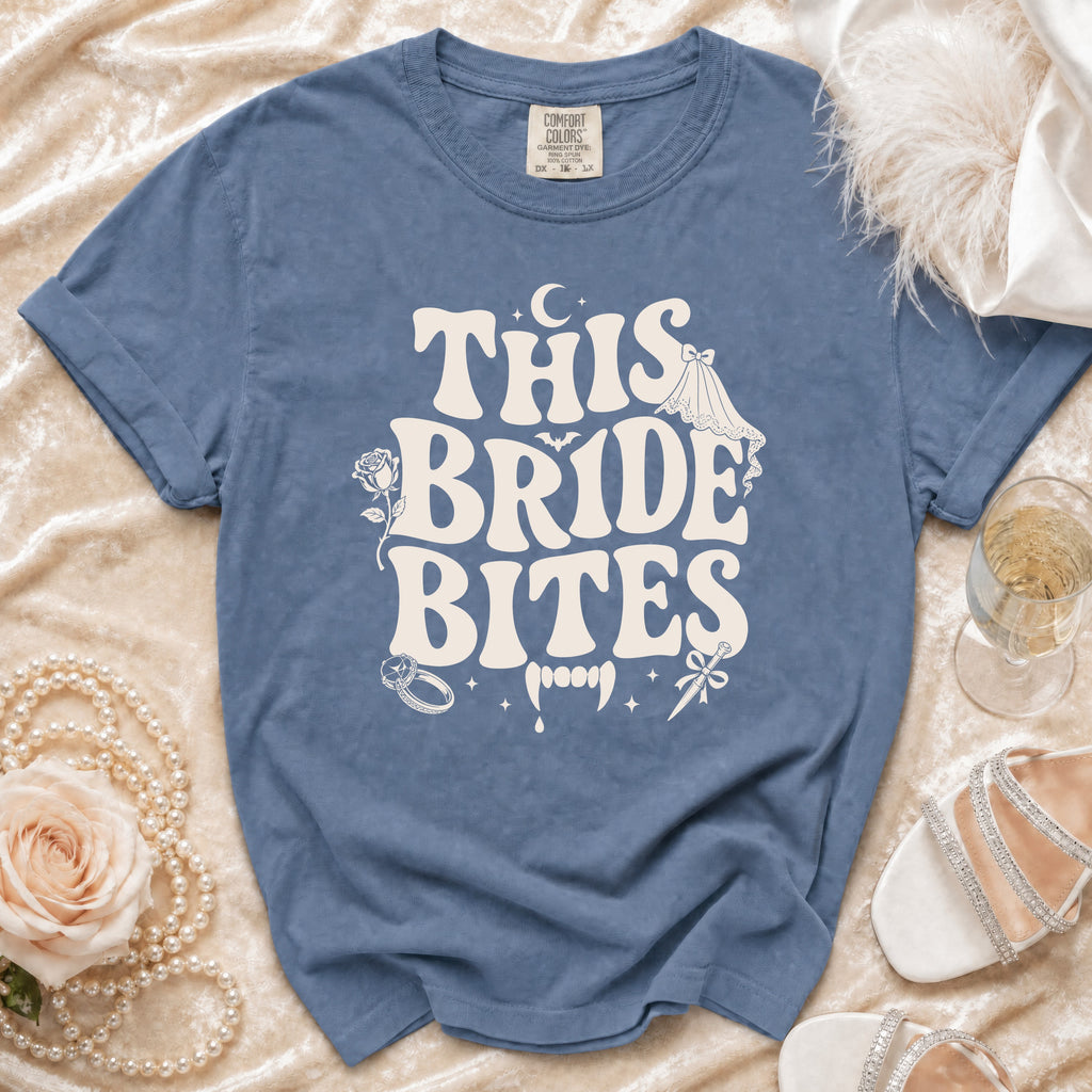 Blue t-shirt with "This Bride Bites" graphic and vampire fangs.