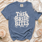 Blue t-shirt with "This Bride Bites" graphic and vampire fangs.