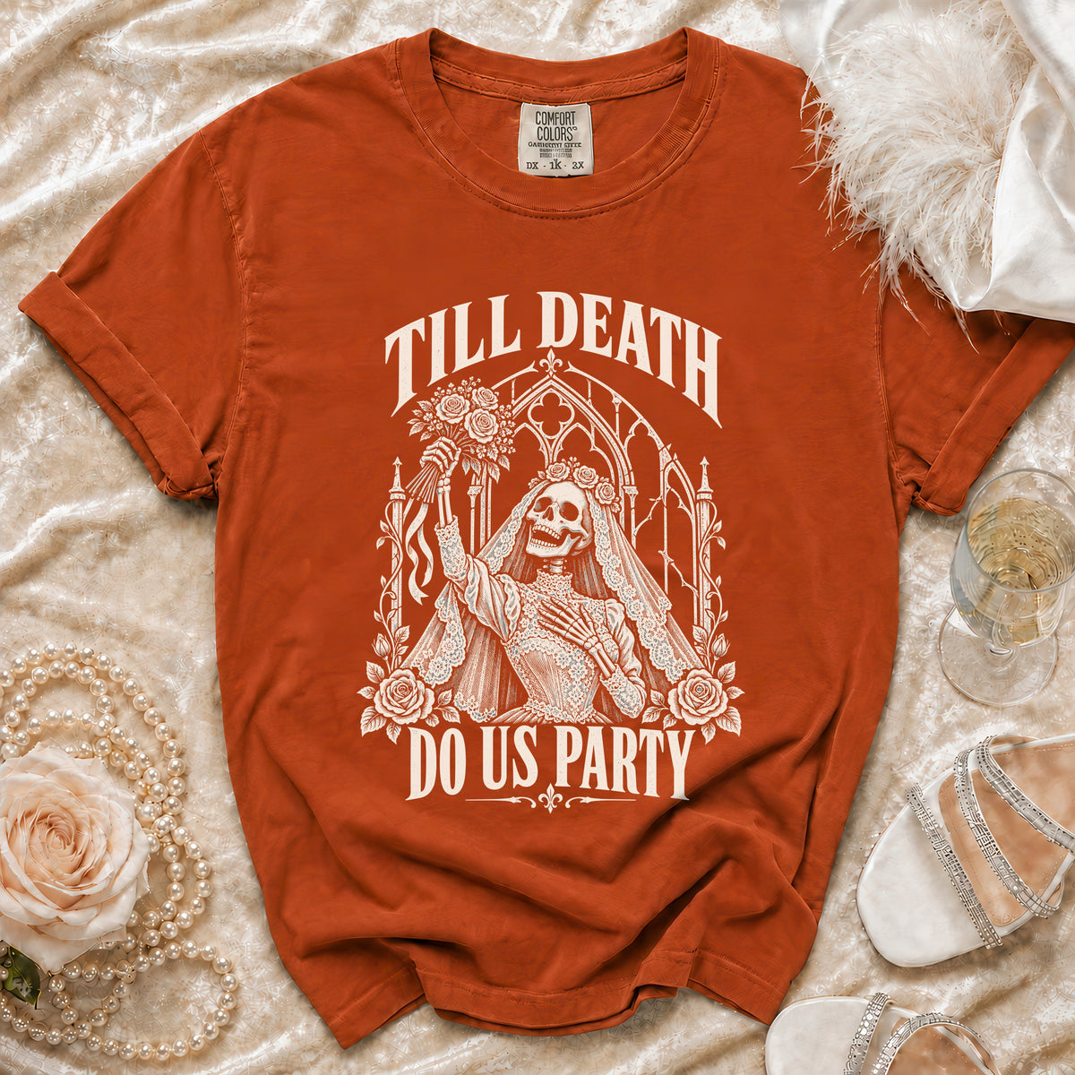 Orange t-shirt with skeleton bride graphic that says "Till Death Do Us Party."