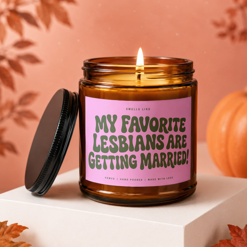 Amber candle with pink label reading "My Favorite Lesbians Are Getting Married!".