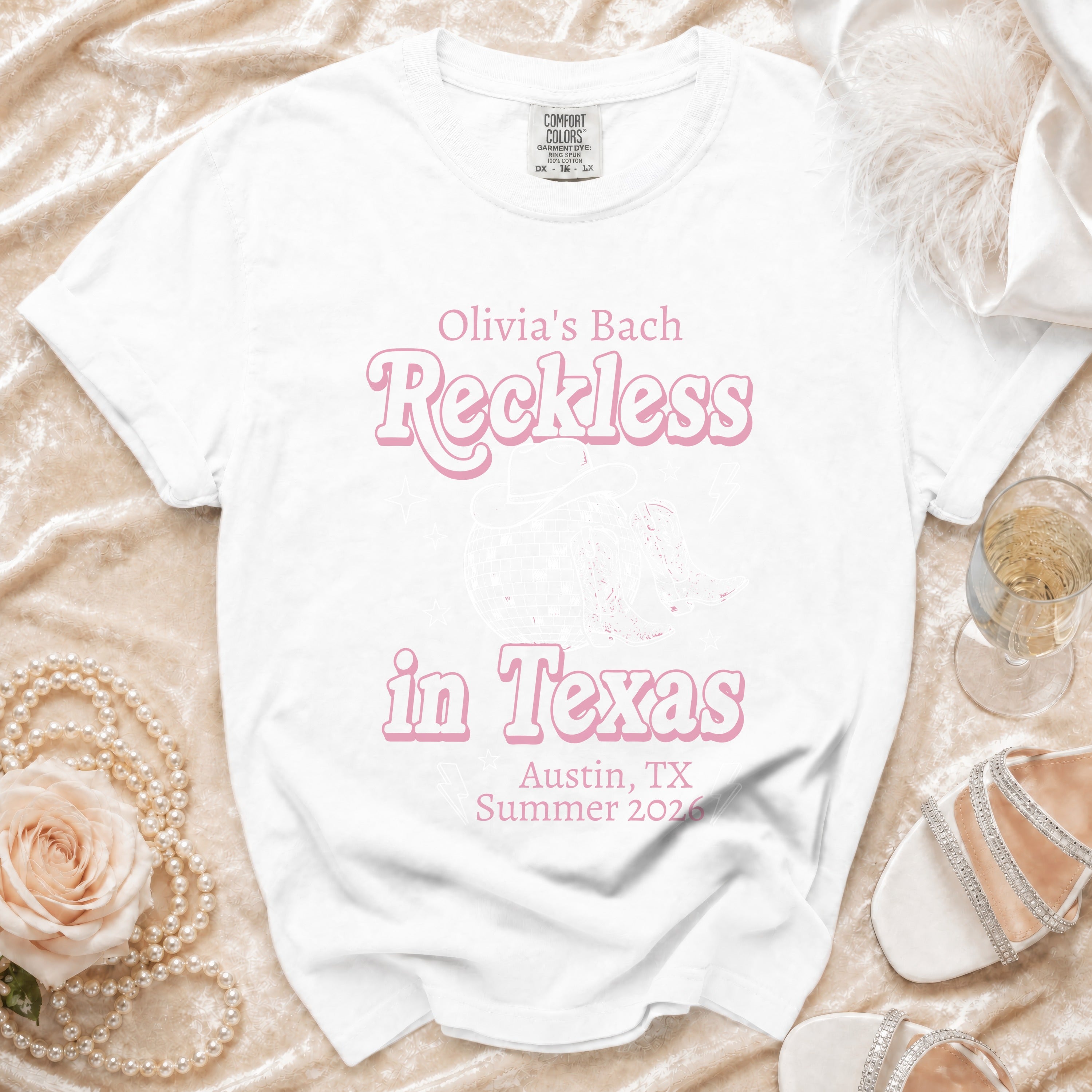 White t-shirt with "Olivia's Bach Reckless in Texas Austin, TX Summer 2026" text.