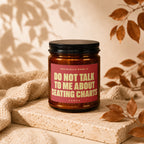 Amber candle with black lid reads "OFFICIALLY OVER IT DO NOT TALK TO ME ABOUT SEATING CHARTS".