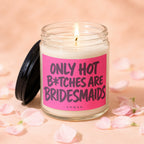 Glass jar candle with pink label reading "ONLY HOT B*TCHES ARE BRIDESMAIDS".