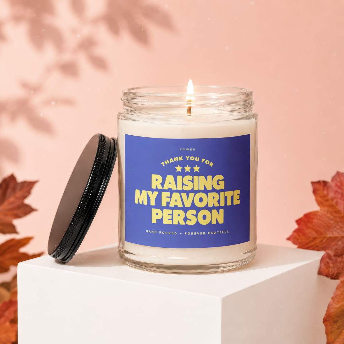 Glass candle with blue label that says "THANK YOU FOR RAISING MY FAVORITE PERSON".