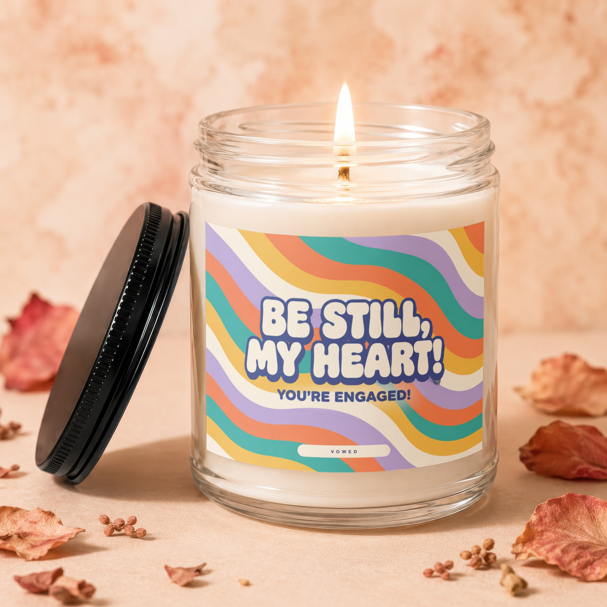Candle with flame and label reading "Be Still, My Heart! You're Engaged!".
