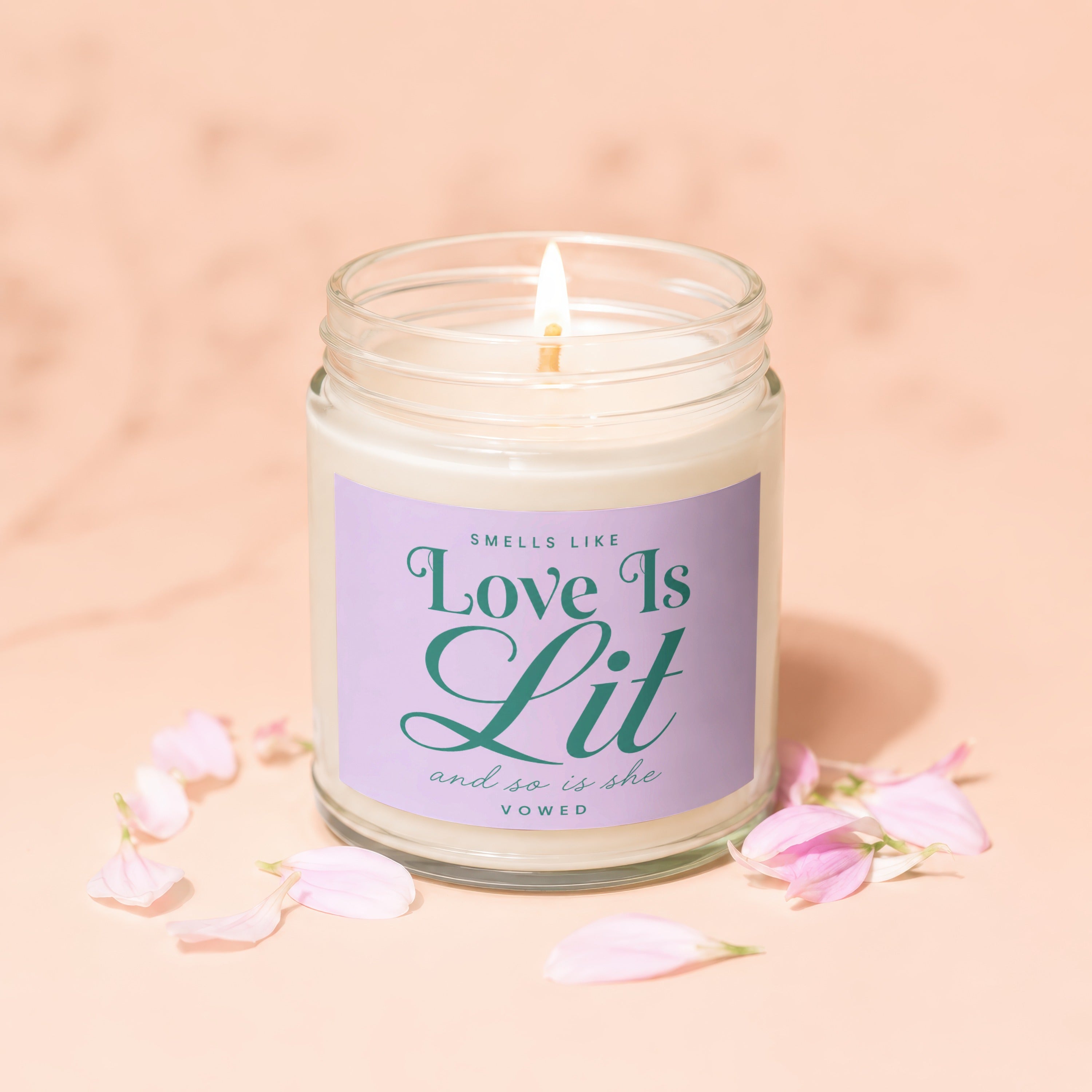 Jar candle with "Love Is Lit and so is she VOWED" text on a lavender label.