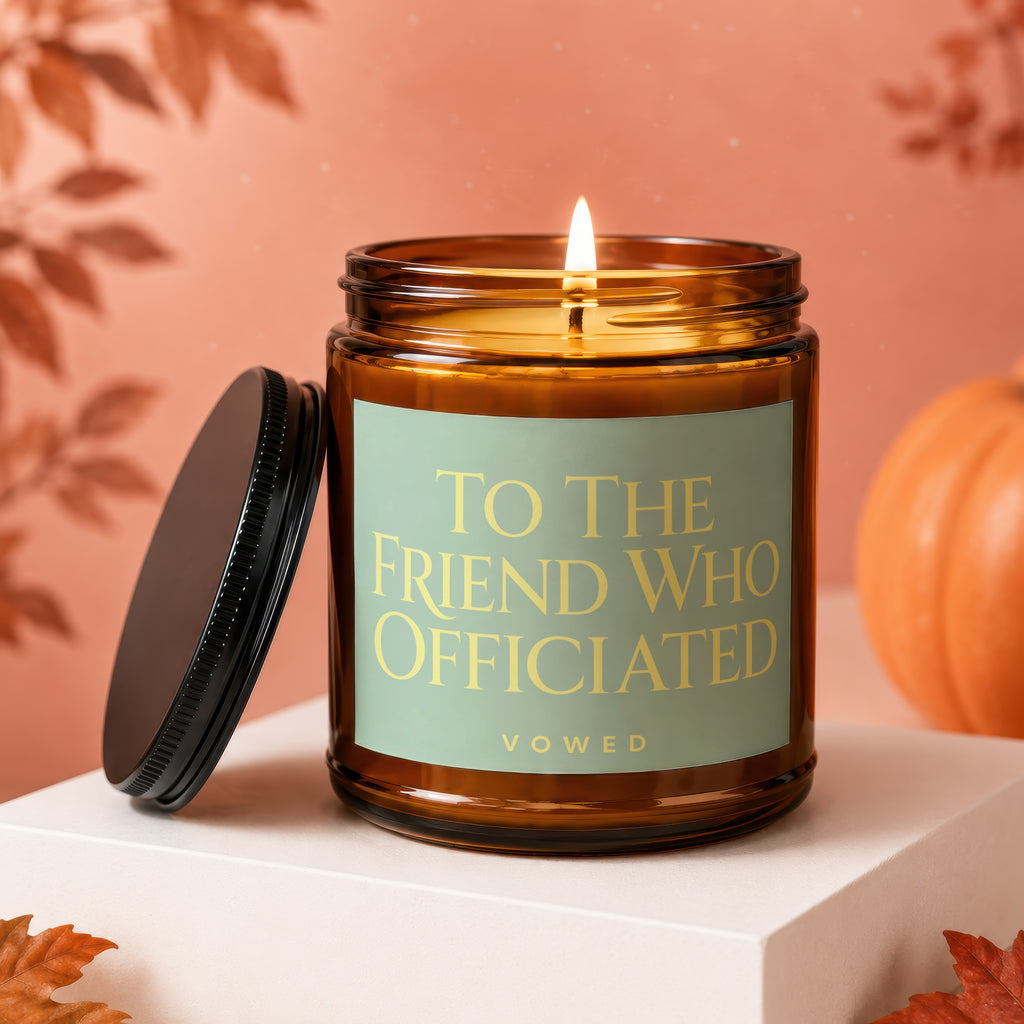 Amber jar candle with "To The Friend Who Officiated" text, lid askew.