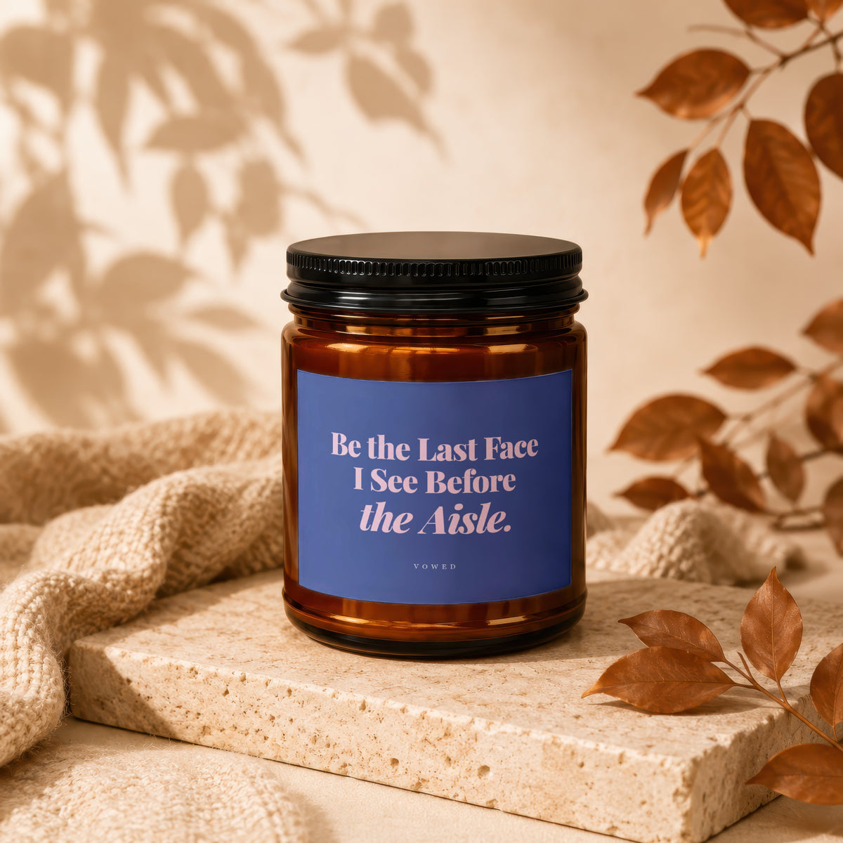 Amber candle with blue label reading "Be the Last Face I See Before the Aisle."