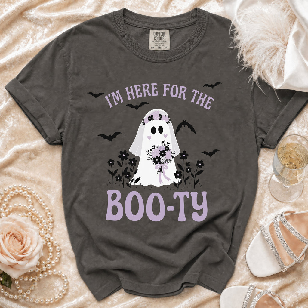 Dark grey t-shirt with a graphic of a ghost, flowers, and bats, reading "I'M HERE FOR THE BOO-TY".
