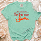 Mint t-shirt with red and orange text reading "This Bride needs a Spritz".