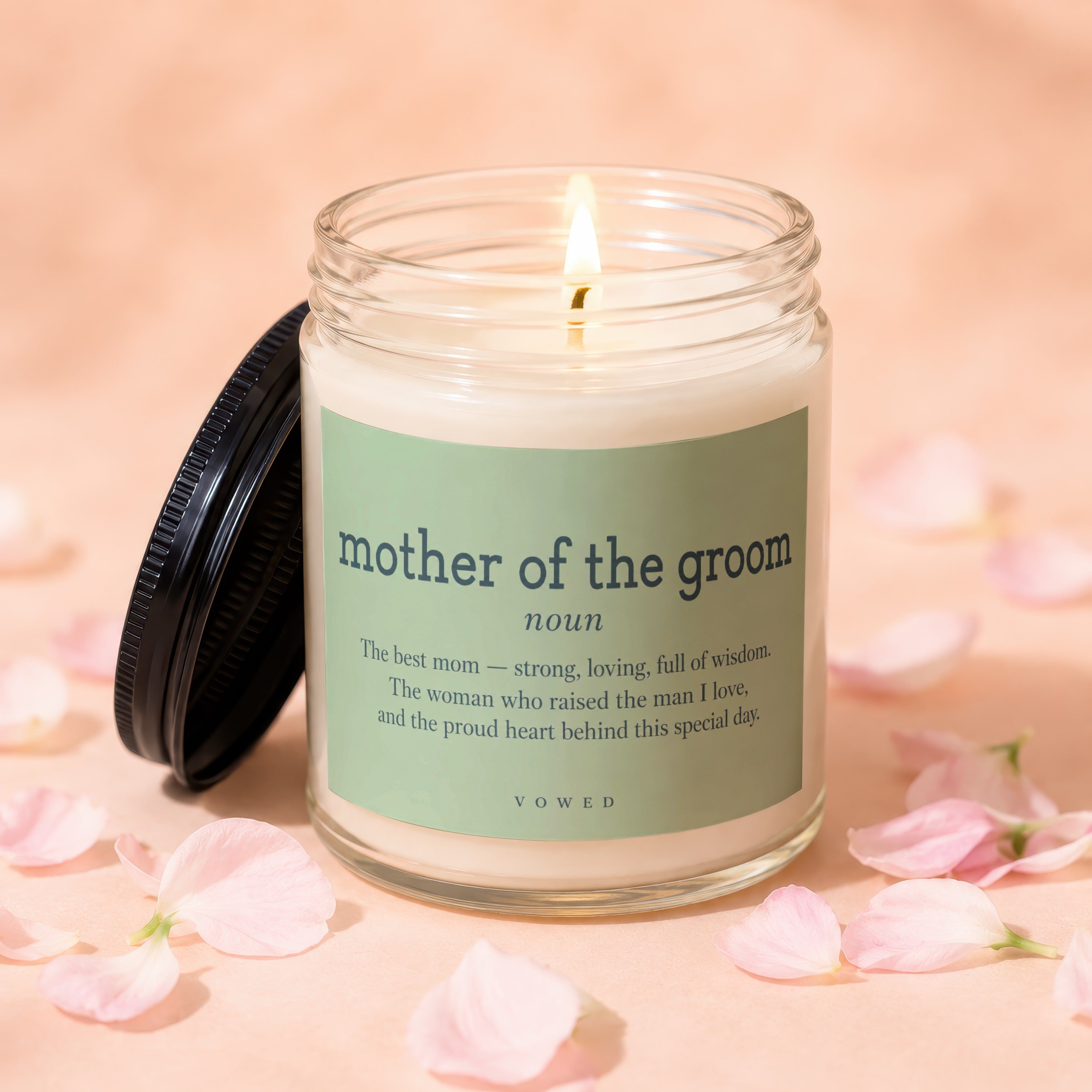 Lit candle in glass jar with "mother of the groom" definition label.