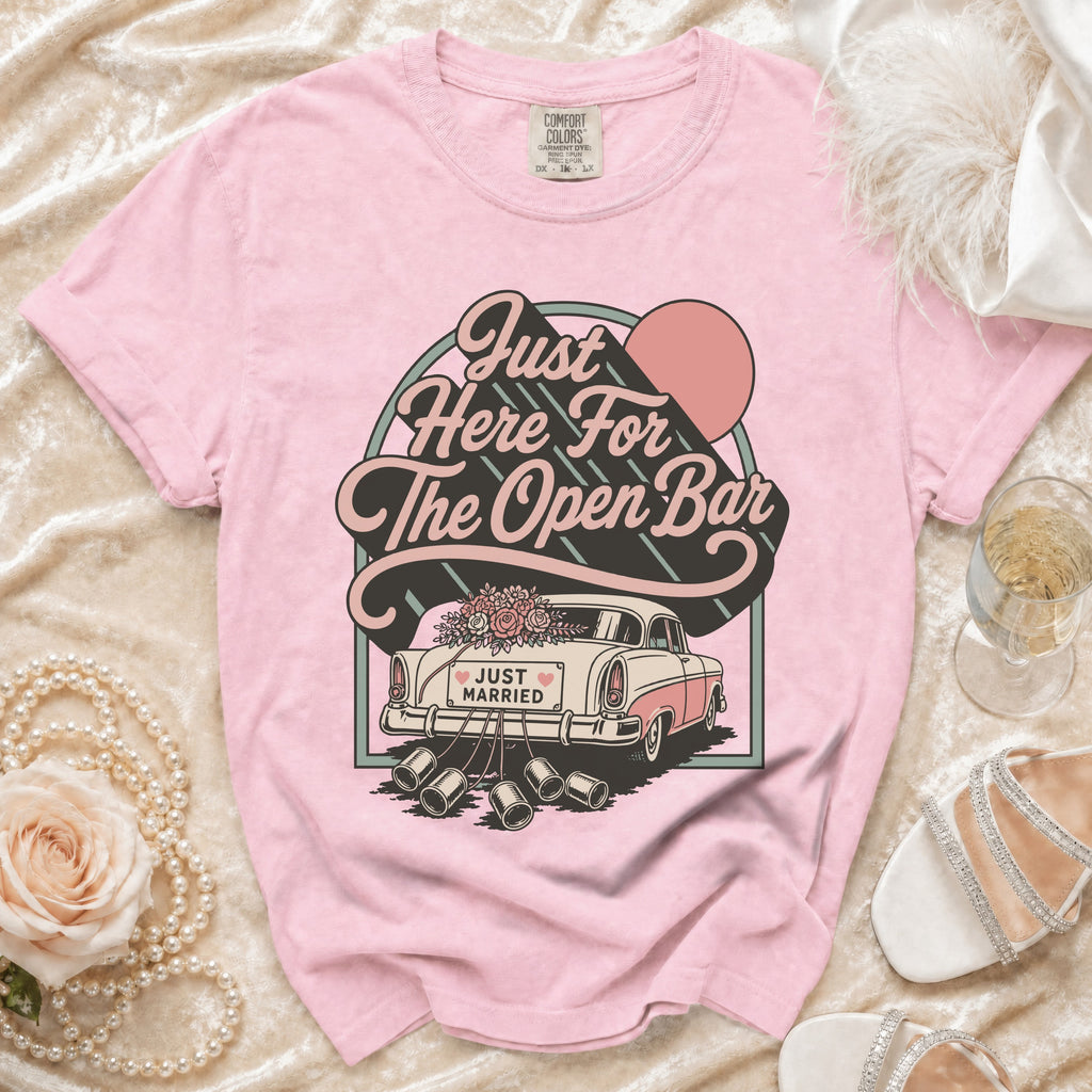 Pink t-shirt with retro graphic of a "Just Married" car and "Just Here For The Open Bar" text.